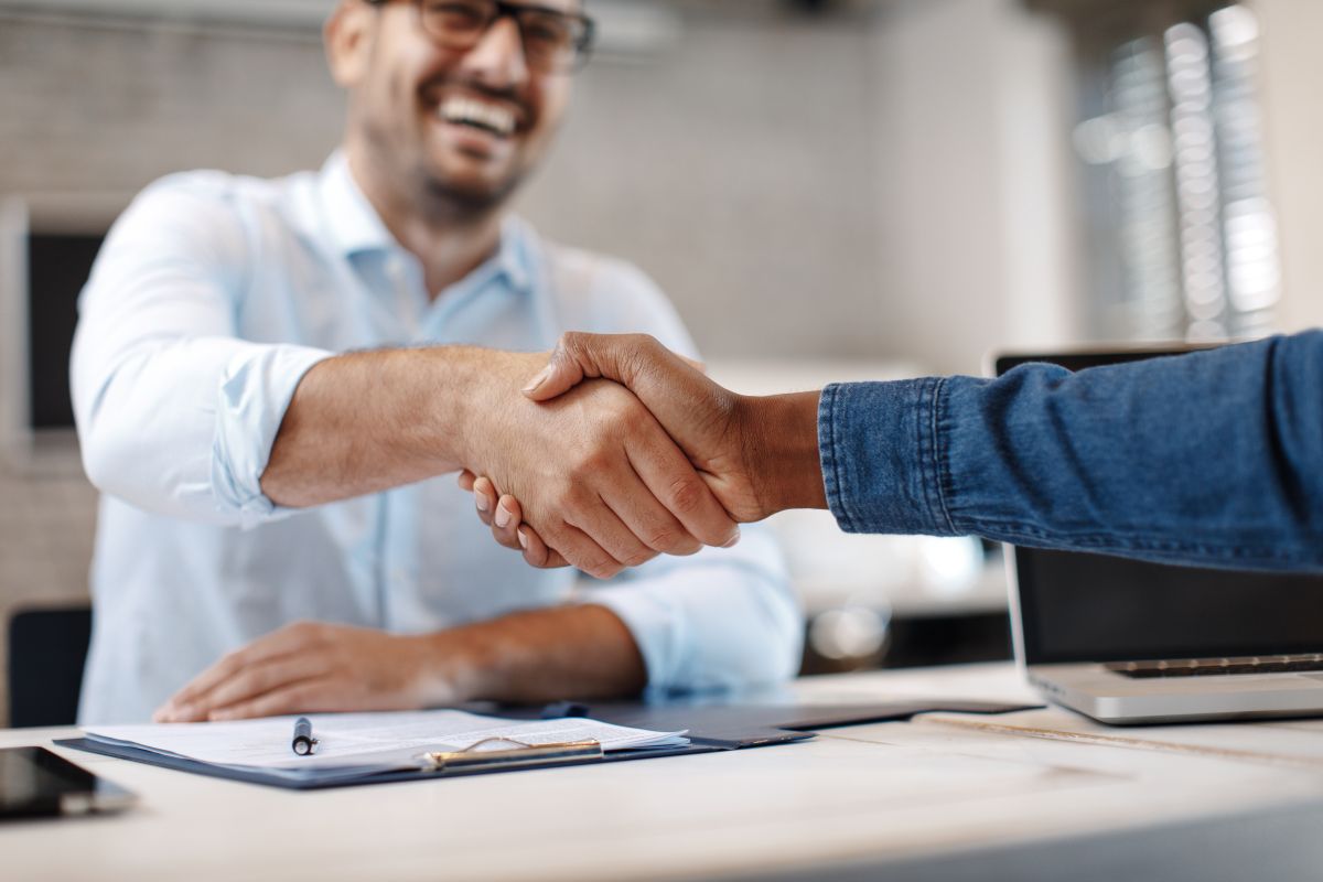 Close-up of a handshake — filing a Minneapolis roof insurance claim with your carrier