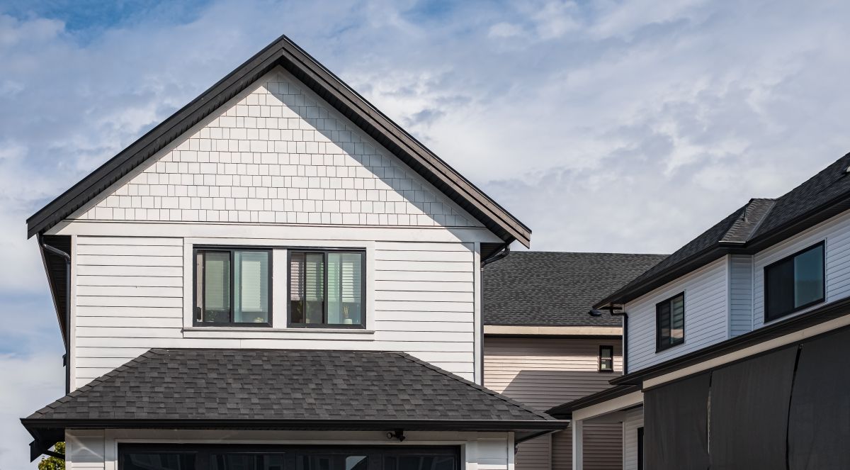 Houses with shingle roof against blue sky