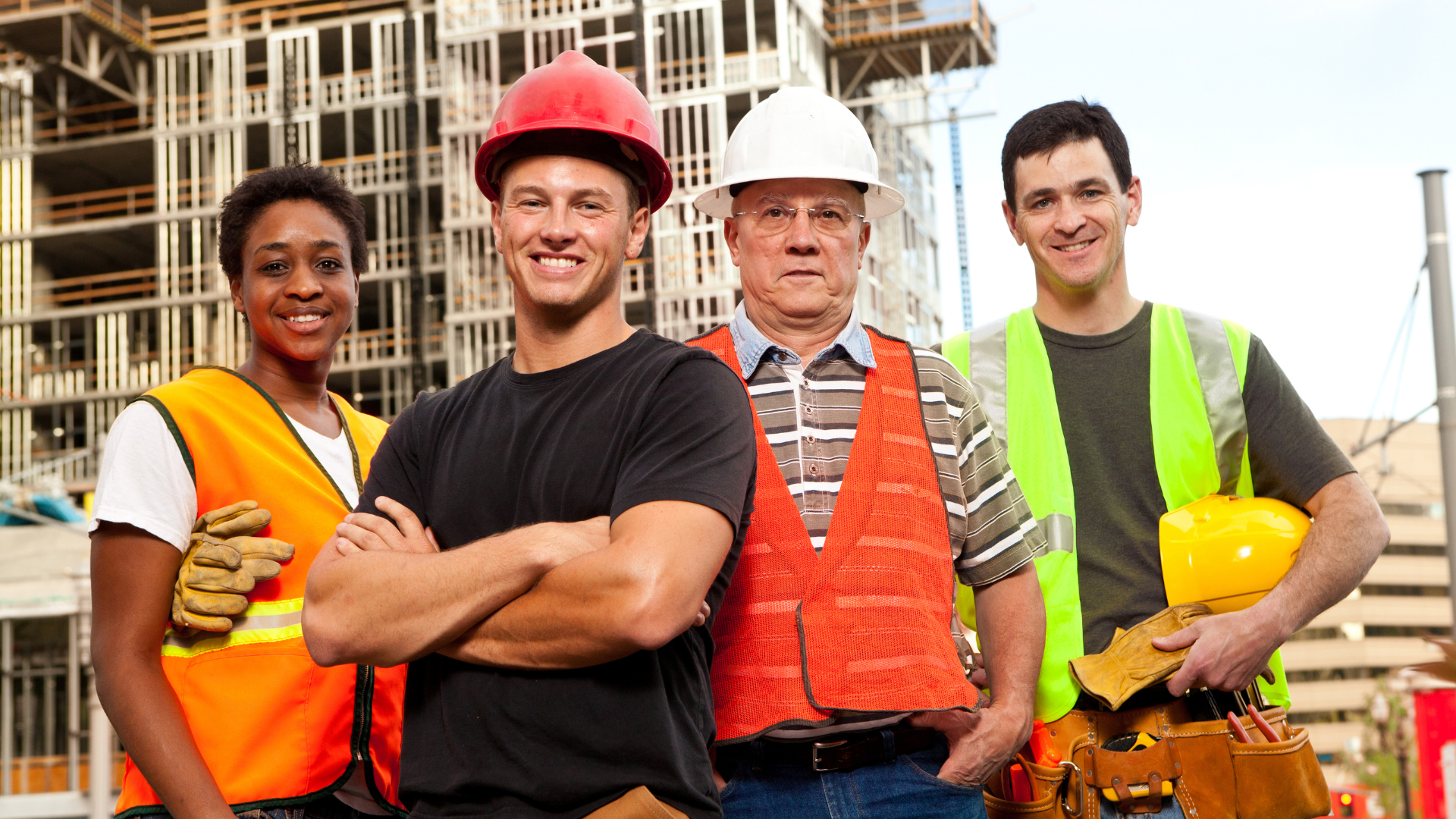 Diverse roofing crew members posing confidently at a construction site, showcasing teamwork and professionalism in the roofing industry.
