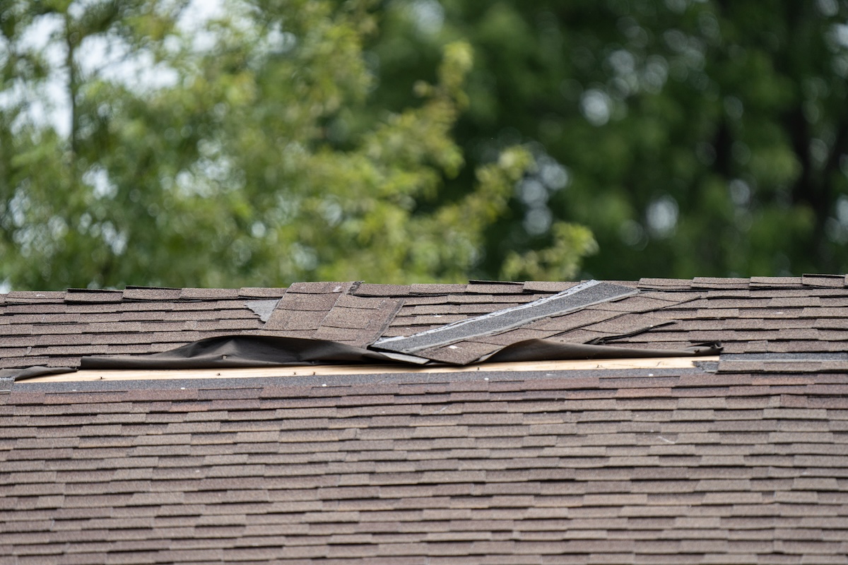 Roof shingles detached and damaged by high winds in a Minneapolis storm
